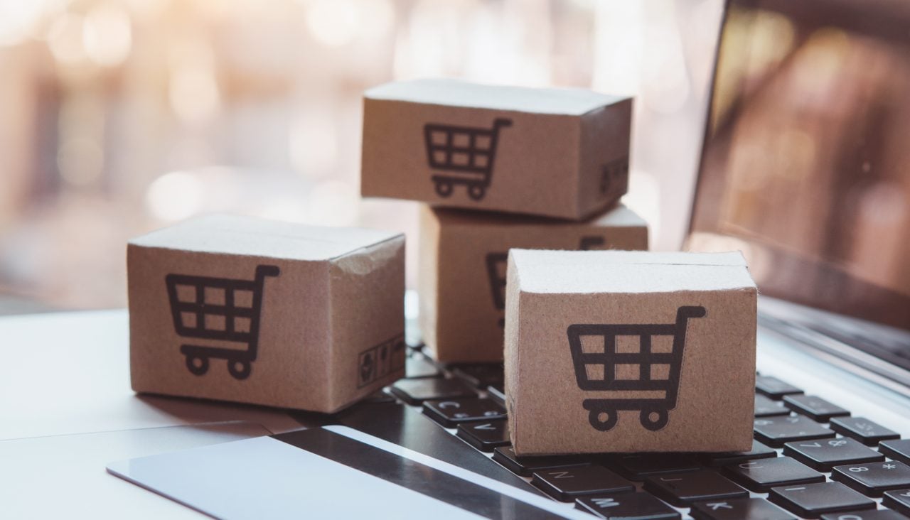 1939658200 Shopping online. Credit card and cardboard box with a shopping cart logo on laptop keyboard. Shopping service on The online web. offers home delivery